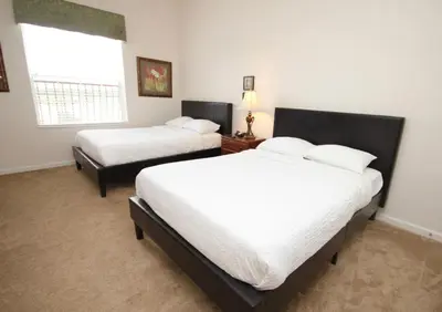 a bedroom with two beds and a window at Shoreway House #231533 in Orlando