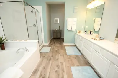 a bathroom with two sinks and a tub and a shower at Cayview Condo #231537 in Orlando