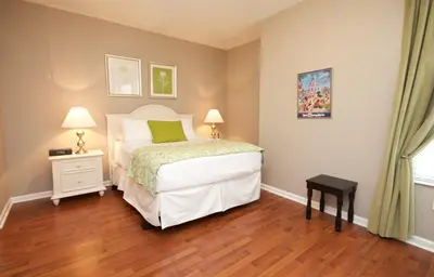 a bedroom with a bed and a wooden floor at Cayview Condo #231536 in Orlando