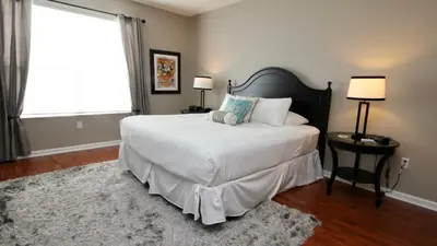 a bedroom with a large white bed and a window at Cayview Condo #231536 in Orlando
