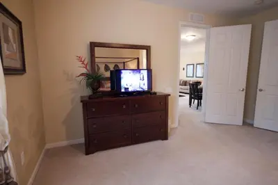 a living room with a tv on top of a dresser at Cayview House #231539 in Orlando