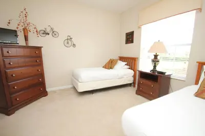 a bedroom with a bed and a dresser and a bed and a dresser at Cayview House #231539 in Orlando