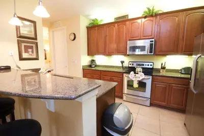 a kitchen with wooden cabinets and a counter top at Cayview House #231539 in Orlando