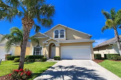 a house with palm trees in front of a driveway at Morningstar Villa #230785 in Orlando