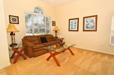 a living room with a couch and a table at Morningstar Villa #230785 in Orlando