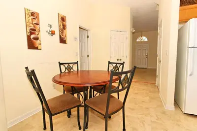 a dining room with a wooden table and chairs at Morningstar Villa #230785 in Orlando