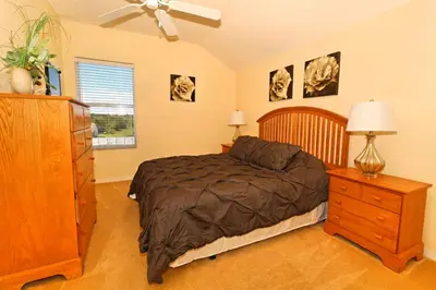 a bedroom with a bed and a dresser and a window at Morningstar Villa #230785 in Orlando