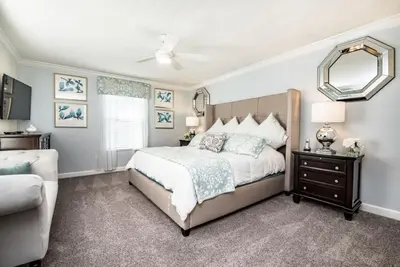 a bedroom with a large bed and a mirror at King Castle Villa #230920 in Kissimmee