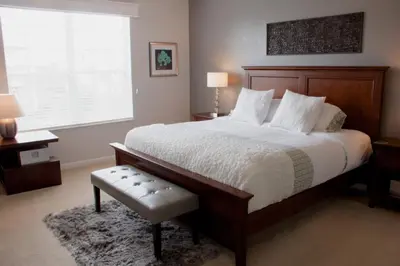 a bedroom with a large bed and a window at Shoreway Condo #231521 in Orlando