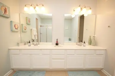 a bathroom with two sinks and a large mirror at Shoreway Condo #231521 in Orlando