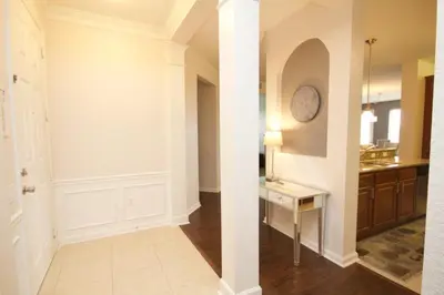 a hallway of a home with a table and a kitchen at Shoreway House #231523 in Orlando