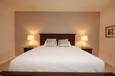 a bedroom with a large white bed with two lamps at Shoreway Condo #231531 in Orlando