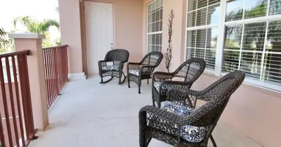 a group of chairs sitting on a porch at Shoreway Condo #231531 in Orlando