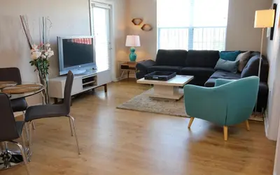 a living room with a couch and a tv at CayView Condo #231544 in Orlando
