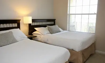 a bedroom with two beds and a window at CayView Condo #231544 in Orlando