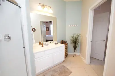 a bathroom with a white sink and a mirror at CayView Condo #231544 in Orlando