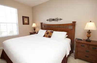 a bedroom with a large white bed and two lamps at CayView Condo #231544 in Orlando