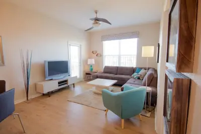a living room with a couch and a tv at CayView Condo #231544 in Orlando