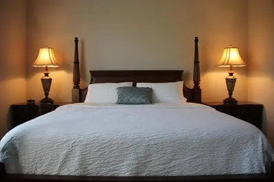 a bedroom with a bed with two lamps on it at Shoreway Condo #231520 in Orlando