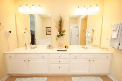 a bathroom with two sinks and a large mirror at Shoreway Condo #231520 in Orlando
