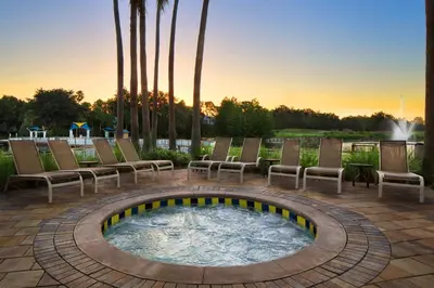 a patio with a hot tub with chairs and a fountain at Marriott's Cypress Harbour Villas in Orlando