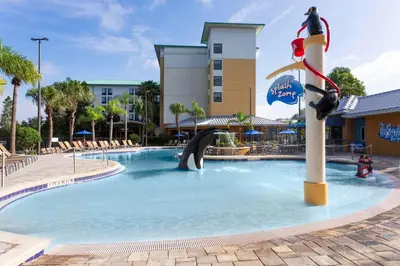 a pool at a resort with a slide at Fairfield Inn Suites by Marriott Orlando At SeaWorld in Orlando