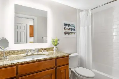 a bathroom with a sink and a toilet and a mirror at Marriott's Grande Vista in Orlando