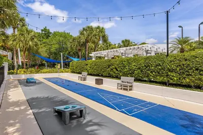 a swimming pool with a picnic table and benches at Marriott's Imperial Palms Villas in Orlando