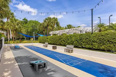a swimming pool with two chairs and a picnic table at Marriott's Royal Palms in Orlando