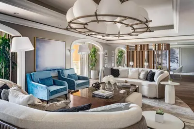 a living room with blue furniture and a chandelier at The Ritz-Carlton Orlando, Grande Lakes in Orlando
