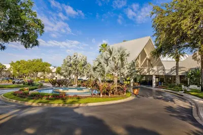 a roundabout in front of a building with palm trees at Marriott's Sabal Palms in Orlando