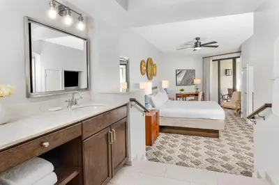 a bathroom with a sink and a bedroom at Marriott's Sabal Palms in Orlando