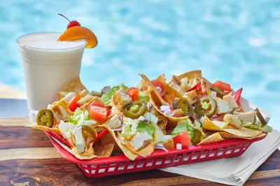 a tray of nachos and a drink on a table at SpringHill Suites by Marriott Orlando at SeaWorld in Orlando