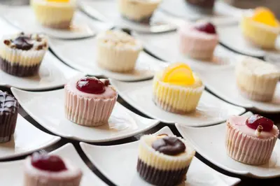 a bunch of cupcakes on plates on a table at SpringHill Suites by Marriott Orlando Lake Buena Vista in Marriott Village in Orlando