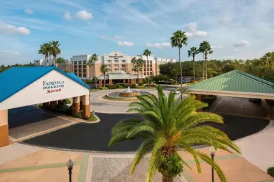 a resort with a palm tree in front of a building at SpringHill Suites by Marriott Orlando Lake Buena Vista in Marriott Village in Orlando