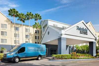 a blue van parked in front of a building at Fairfield Inn Orlando Airport in Orlando