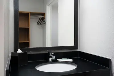 a bathroom with a sink and a mirror at Fairfield Inn Orlando Airport in Orlando