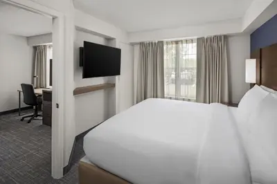 a hotel room with a bed and a television at Residence Inn by Marriott Orlando East/UCF Area in Orlando