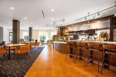a bar in a restaurant with tables and chairs at Courtyard Orlando Altamonte Springs Maitland in Orlando