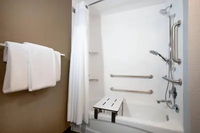 a bathroom with a shower and a bath tub at Courtyard Orlando Altamonte Springs Maitland in Orlando