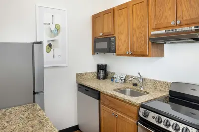 a small kitchen with a sink and a refrigerator at TownePlace Suites by Marriott Orlando East/UCF Area in Orlando
