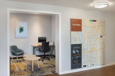 an office with a map and a table and chairs at TownePlace Suites by Marriott Orlando East/UCF Area in Orlando