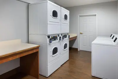 a kitchen with two washer and dryer at TownePlace Suites by Marriott Orlando East/UCF Area in Orlando