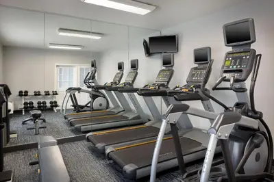 a gym with several treadmills and elliptical machines at TownePlace Suites by Marriott Orlando East/UCF Area in Orlando