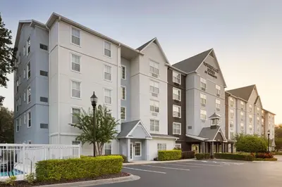 a rendering of the exterior of a hotel at TownePlace Suites by Marriott Orlando East/UCF Area in Orlando