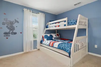 a white bunk bed in a room with blue walls at Five Bedrooms Home with Pool 4851 in Kissimmee