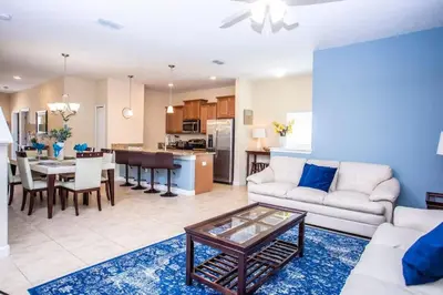 a living room with a couch and a table at Five Bedrooms Home with Pool 4851 in Kissimmee