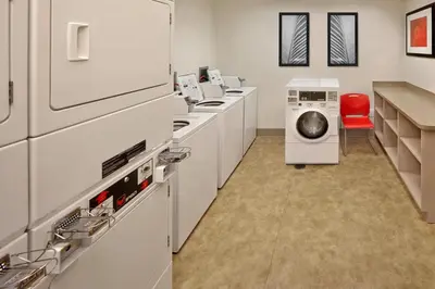 a laundry room with a washer and a washing machine at Residence Inn Orlando Lake Mary in Lake Mary