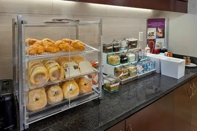 a display case filled with lots of different types of bread at Residence Inn Orlando Lake Mary in Lake Mary