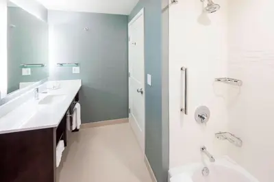 a bathroom with a white sink and a shower at Residence Inn by Marriott Near Universal Orlando in Orlando